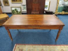 A FRENCH PROVINCIAL DRAWLEAF FRUIT WOOD TABLE, with a single frieze drawer, raised on turned support