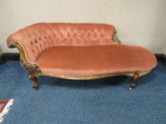 A VICTORIAN WALNUT UPHOLSTERED SHAPED SETTEE