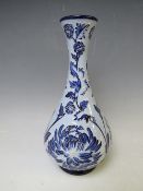 A MOORCROFT POTTERY FLORIAN ONION VASE, with tubelined floral sprays on a contrasting blue ground,