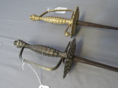 TWO RAPIER OR SPADROON STYLE SWORDS, with tapering square section blades and fancy cast hilts in the