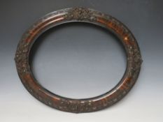 A 19TH CENTURY OVAL DECORATIVE PAINTED FRAME, frame W 8 cm, rebate 50 x 40 cm