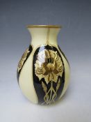 A COBRIDGE BALUSTER VASE, decorated with panels of Art Nouveau flowers, on an ivory body,