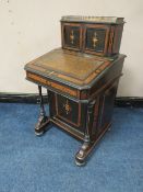 A 19TH CENTURY EBONISED AND WALNUT DAVENPORT, the twin door upper section opening to drawers and