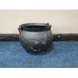 A LARGE AND HEAVY CAST CAULDRON, with swing handle, on three feet, H 38 cm, W 49 cm A/FCondition