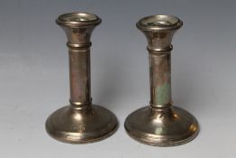 A PAIR OF HALLMARKED SILVER CANDLESTICKS - BIRMINGHAM 1922, one with damage to base, bases filled, H
