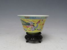 A CHINESE YELLOW GROUND DRAGON BOWL, with hardwood stand, bowl Dia. 10.5 cm, H 6 cm, overall H 9 cm