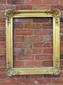 A GILT RECTANGULAR PICTURE FRAME, with foliate moulded detail to each corner, rebate 68 x 55 cm