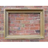 A GILT RECTANGULAR PICTURE FRAME, with egg and dart moulded detail, rebate 82 x 57 cm