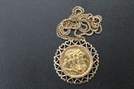 A QUEEN ELIZABETH II SOVEREIGN - 1974, in an unmarked heart design yellow metal mount hung on