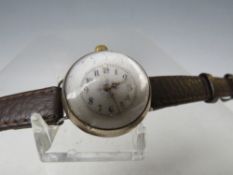 AN UNUSUAL TRENCH WRISTLET WATCH, with domed glass and visible workings, Dia. 2.5 cm