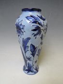 A MOORCROFT POTTERY FLORIAN VASE, with tubelined floral sprays on contrasting blue ground, marks and