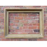 A GILT RECTANGULAR PICTURE FRAME, with egg and dart moulded detail, rebate 82 x 57 cm