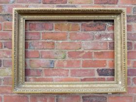 A GILT RECTANGULAR PICTURE FRAME, with egg and dart moulded detail, rebate 82 x 57 cm