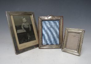 THREE VINTAGE HALLMARKED SILVER PHOTOGRAPH FRAMES, with strut backs, site sizes - 17.5 x 12 cm, 13.5