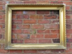 A GILT RECTANGULAR PICTURE FRAME, with acanthus moulded detail to each corner, rebate 83 x 58 cm
