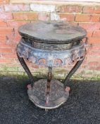 AN ORIENTAL EBONISED TWO TIER JARDINIERE STAND, decorated in typical style with gilt and coloured