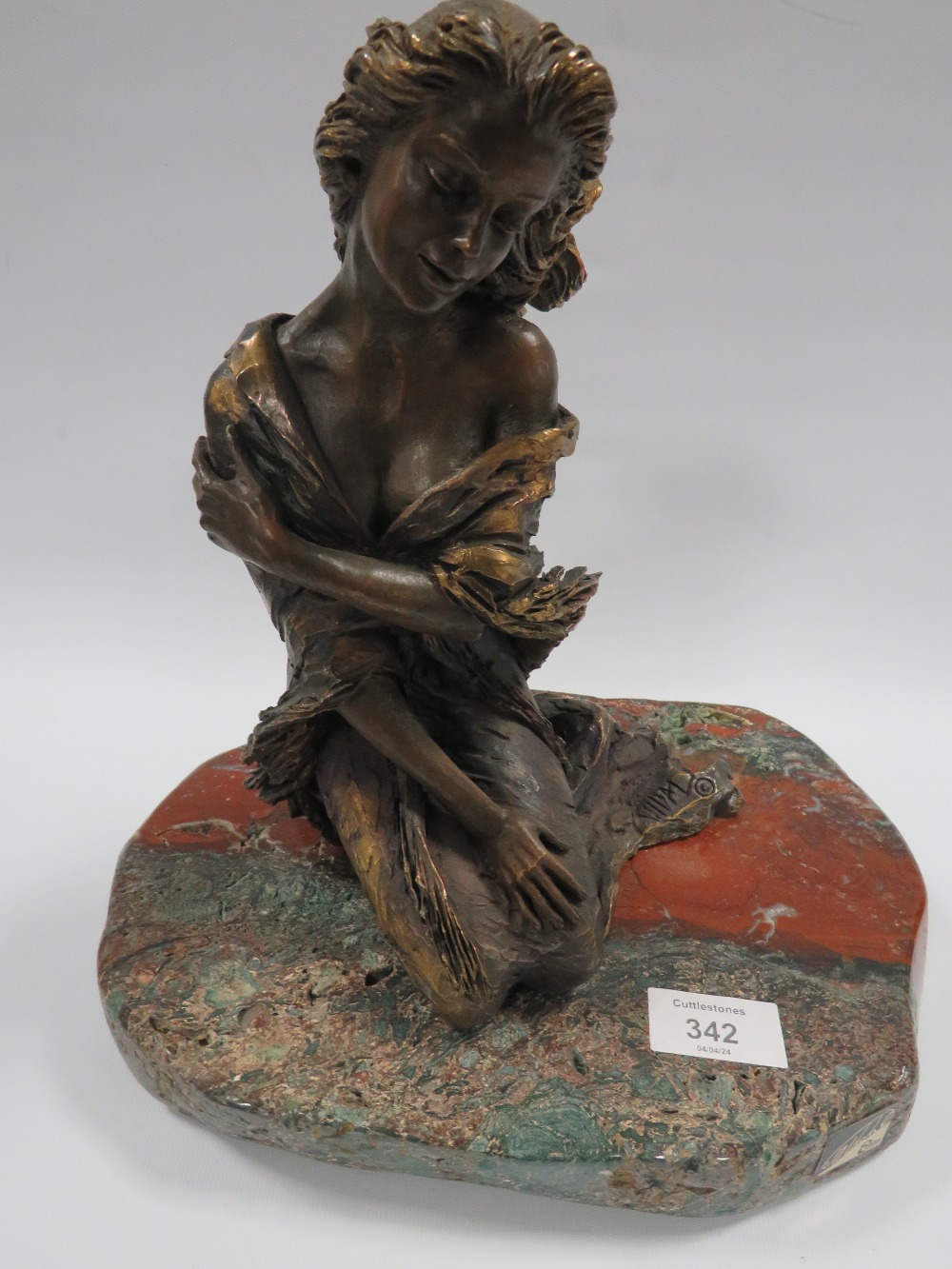 AN EBANO BRONZED SCULPTURE FROM THE VIDAL COLLECTION DEPICTING A KNEELING SEMI NUDE GIRL, raised