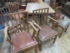 A LARGE OAK DRAWER LEAF TABLE AND EIGHT CHAIRS