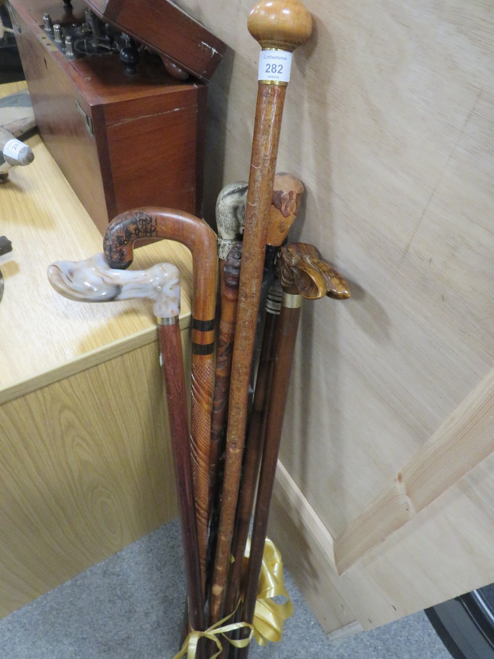 A SELECTION OF ASSORTED WALKING STICKS TO INCLUDE ONE IN THE FORM OF A HARE ETC