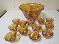 A VINTAGE IRIDESCENT PUNCH BOWL AND GLASSES SET