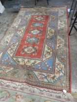 A VINTAGE WOOLLEN RUG - APPROX 260 x 164 cm