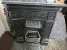A VINTAGE CAST IRON FIRE SURROUND AND GRATE
