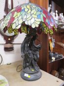 A LARGE FIGURATIVE TABLE LAMP WITH TIFFANY STYLE SHADE A/F