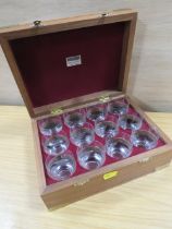 A CASED SET OF TWELVE ENGRAVED TOT GLASSES