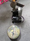 AN ANTIQUE PROJECTOR AND FILM REELS A/F