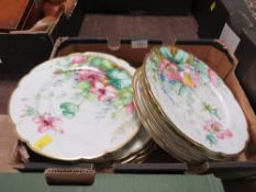 A TRAY OF FLORAL HAND PAINTED PLATES WITH SCALLOPED EDGES