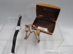 A HALLMARKED 9 CARAT GOLD LADIES ACCURIST WRIST WATCH TOGETHER WITH A 9 CARAT GOLD CASED EXAMPLE AND