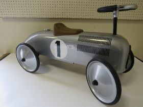 A CHILDREN'S VINTAGE STYLE RIDE ON SILVER RACING CAR