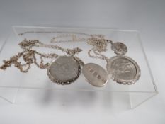 TWO MOUNTED CROWN PENDANTS ON SILVER CHAINS TOGETHER WITH A HALLMARKED TABLET EXAMPLE AND A