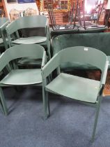 A SET OF FOUR MODERN GREEN PLASTIC STACKING CHAIRS