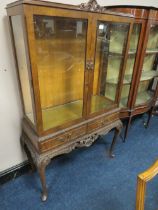 A 20TH CENTURY WALNUT GLAZED TWO DRAWER CABINET ON CABRIOLE LEGS