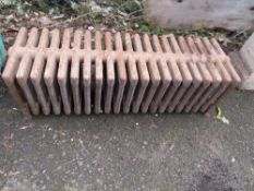 A VINTAGE CAST IRON LOW 21 FIN RADIATOR