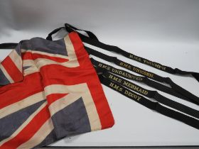 A COLLECTION OF ROYAL NAVY HAT BANDS AND A VINTAGE UNION JACK FLAG