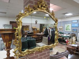 A MODERN GILT SHAPED WALL MIRROR