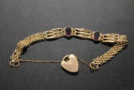 A VICTORIAN ROLLED GOLD BRACELET SET WITH AMETHYST COLOUR STONES
