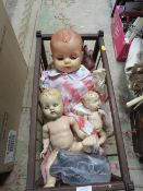 A VINTAGE DOLLS CRADLE WITH 4 VARIOUS DOLLS A/F