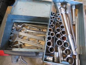 A METAL TOOL BOX CONTAINING LARGE SOCKET SET AND A SELECTION OF SPANNERS