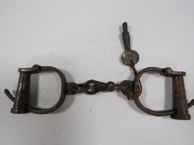 A PAIR OF VICTORIAN HAND CUFFS