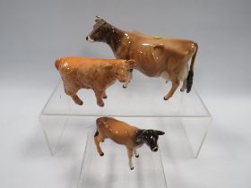 A BESWICK JERSEY COW NEWTON TINKLE TOGETHER WITH A CALF AND A HIGHLAND CALF (3)
