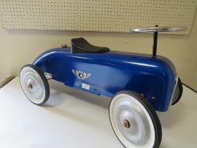 A CHILDRENS VINTAGE STYLE RIDE ON BLUE RACING CAR