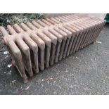 A VINTAGE CAST IRON LOW 21 FIN RADIATOR