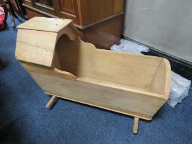 AN ANTIQUE PINE ROCKING CRADLE / CRIB