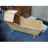 AN ANTIQUE PINE ROCKING CRADLE / CRIB