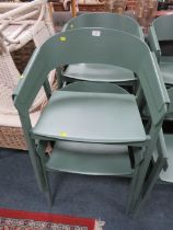 A SET OF FOUR MODERN GREEN PLASTIC STACKING CHAIRS