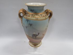 A TWIN HANDLED HAND PAINTED NORITAKE VASE PAINTED WITH DESERT SCENES OF MEN ON CAMELS