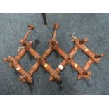 A VINTAGE SET OF FOLDING CONCERTINA COAT/HAT HOOKS